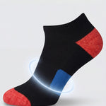Black and red sock with targeted arch support on a light gray background