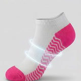 White and pink ankle sock with targeted arch support on a light gray background