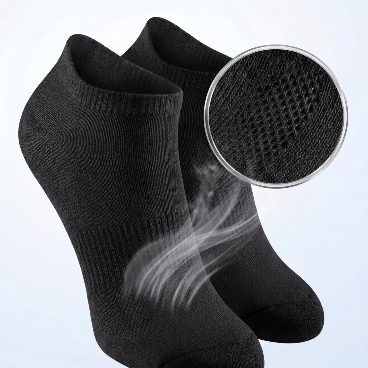 Black ankle socks with breathable mesh ventilation feature on a light gray background