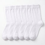 Six pairs of plain white crew socks arranged side by side on a clean white background.