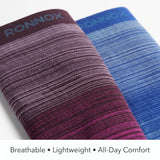 Two rolled athletic socks by RONNOX on a white background, one in dark purple with pink gradient stripes and the other in blue with lighter blue stripes. Text at the bottom reads 'Breathable • Lightweight • All-Day Comfort'.
