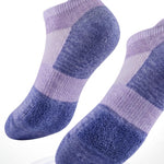 Pair of purple socks with text about cushioned sole comfort on a white background