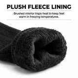 Close-up of a black knit sock rolled to show its plush fleece lining, with text above reading 'PLUSH FLEECE LINING' and 'Brushed interior traps heat to keep feet warm in freezing temperatures.'.