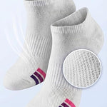 White socks with mesh ventilation on a light gray background