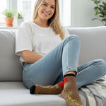 Woman sitting on a couch wearing colorful socks with text