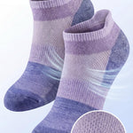 Pair of purple and gray socks with breathable mesh ventilation on a light blue background.