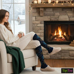 Woman sitting in a cozy living room with a fireplace, wearing blue argyle socks.