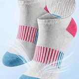 Gray socks with red and blue accents on a light blue background, featuring breathable mesh text.