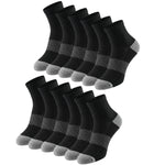 Multiple pairs of black socks with gray accents on a white background