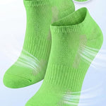 Green socks with breathable mesh design on a light gray background