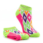 A pair of low-cut ankle socks with a vibrant geometric pattern in neon green, hot pink, orange, purple, and white, shown on a clean white background.