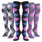 Six pairs of knee-high argyle socks displayed on invisible forms against a white background. The designs include gray, black, white, blue, pink, and purple argyle patterns.