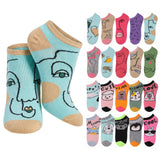 A set of low-cut ankle socks shown on a white background, featuring a large stylized face design on the front pair and a grid of smaller multicolor sock designs on the right. The socks include pastel and bright colors with cartoon and face illustrations.