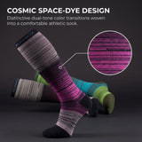 A pair of athletic compression socks with a cosmic space-dye design, featuring a prominent purple and black striped sock in the foreground, with other multicolor socks (green, blue, gray) blurred in the background. A circular inset highlights the knit texture of the purple pattern.