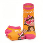 A pair of low-cut ankle socks featuring a cartoon monkey wearing pink heart-shaped glasses and a pink bow, with the name 'Fienn' in white script. The socks are primarily orange with bright pink cuffs, heels, and toes, and are displayed on a clean white background.