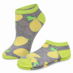 A pair of low-cut ankle socks with a gray heather base featuring a yellow lemon print and bright lime green trim on the cuff, toe, and heel, displayed on a clean white background.