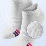 A pair of white low-cut athletic socks with pink and purple stripes near the toes, shown on a light blue background with marketing text and a circular inset highlighting the breathable mesh texture.