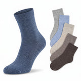 A single heathered blue ankle sock is shown prominently in the foreground, with five additional socks in gray, light blue, cream, taupe, and dark brown fanned out behind it on a white background.