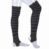 Black and gray striped over-the-knee compression sleeves shown on a transparent mannequin leg form against a white background.