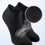 Black ankle socks with breathable mesh ventilation feature on a light gray background