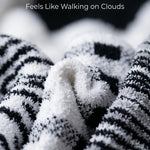 Close-up of zebra-patterned fabric with text 'Ultra Soft & Plush Feels Like Walking on Clouds'.