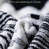 Close-up of zebra-patterned fabric with text 'Ultra Soft & Plush Feels Like Walking on Clouds'.