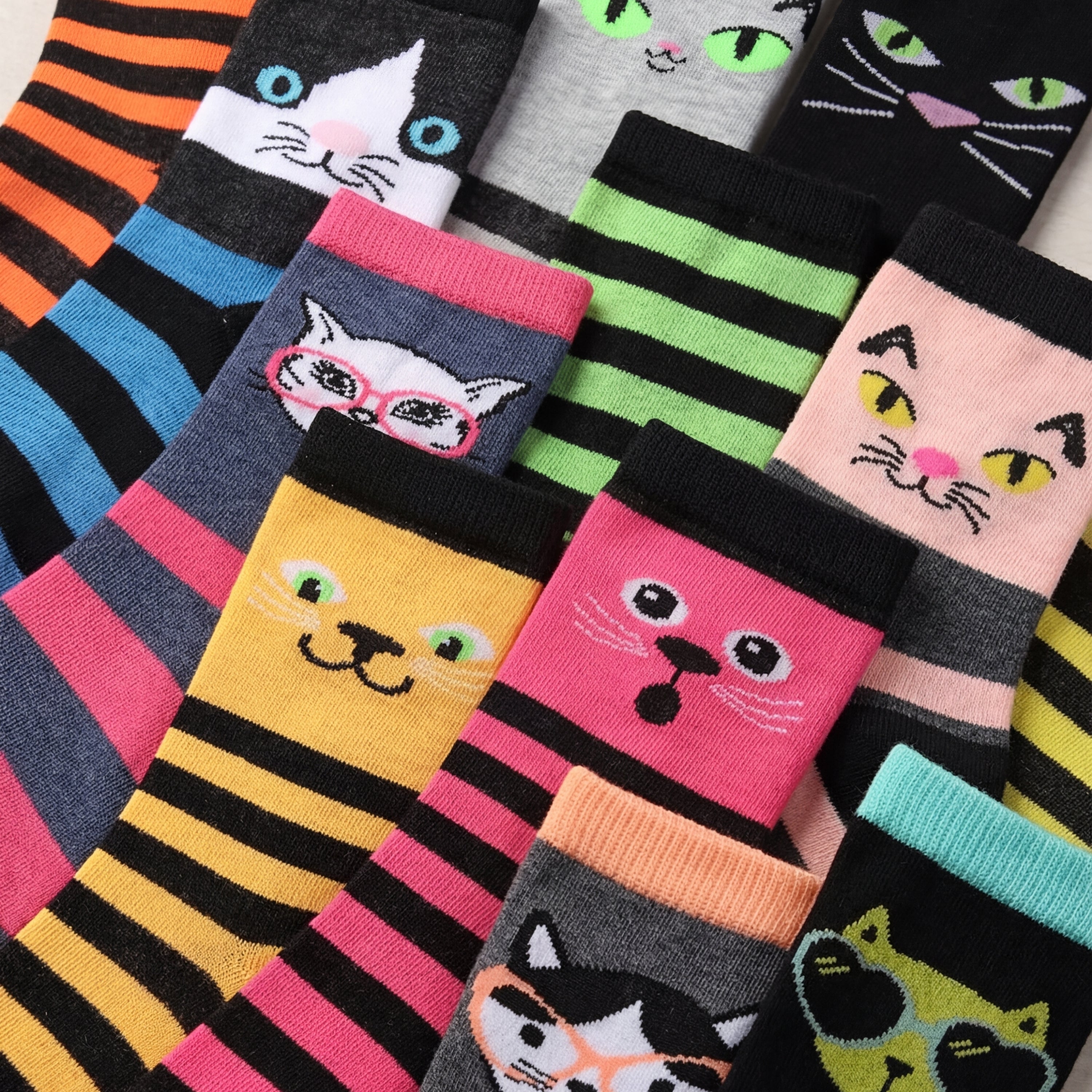 Colorful cat-themed socks with various designs on a white background