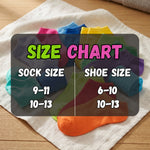 Colorful socks with a size chart indicating sock and shoe sizes on a wooden surface.