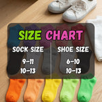 Colorful socks with a size chart showing sock and shoe size correspondences on a wooden surface.