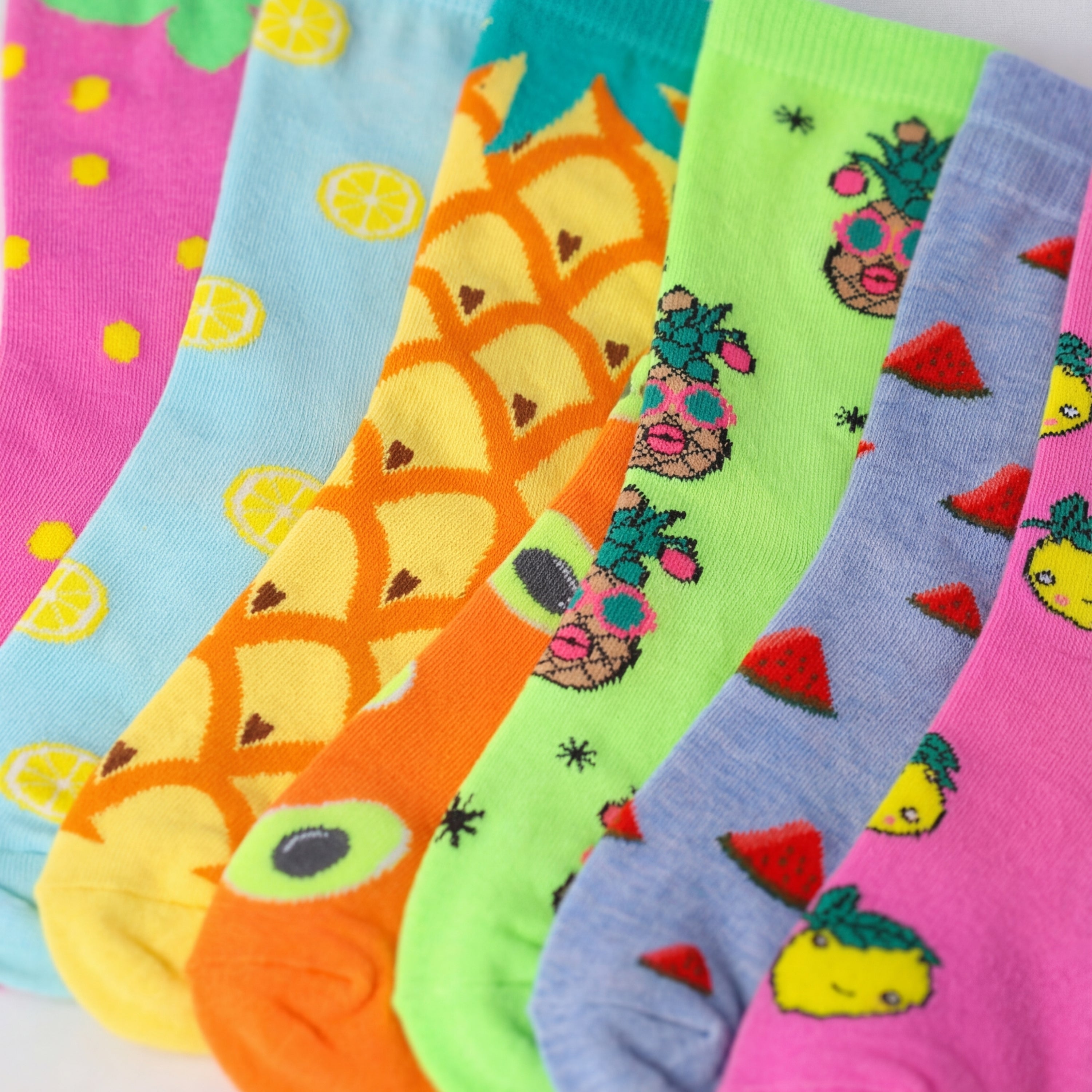 Colorful socks with various patterns arranged in a row.
