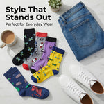 Colorful socks with various patterns, a cup of coffee, and jeans on a marble surface.