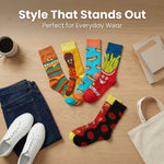 Colorful socks with various designs on a wooden surface with shoes and jeans.