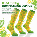 Three yellow compression socks with green tropical leaf and flower patterns, shown on a white background with promotional text and leaf graphics.