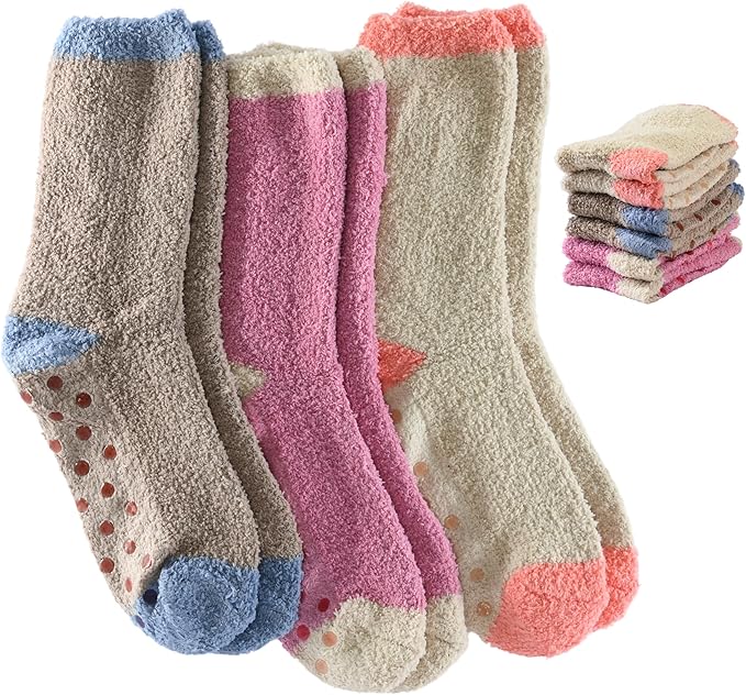 Set of colorful socks with a stack of additional pairs in the background.