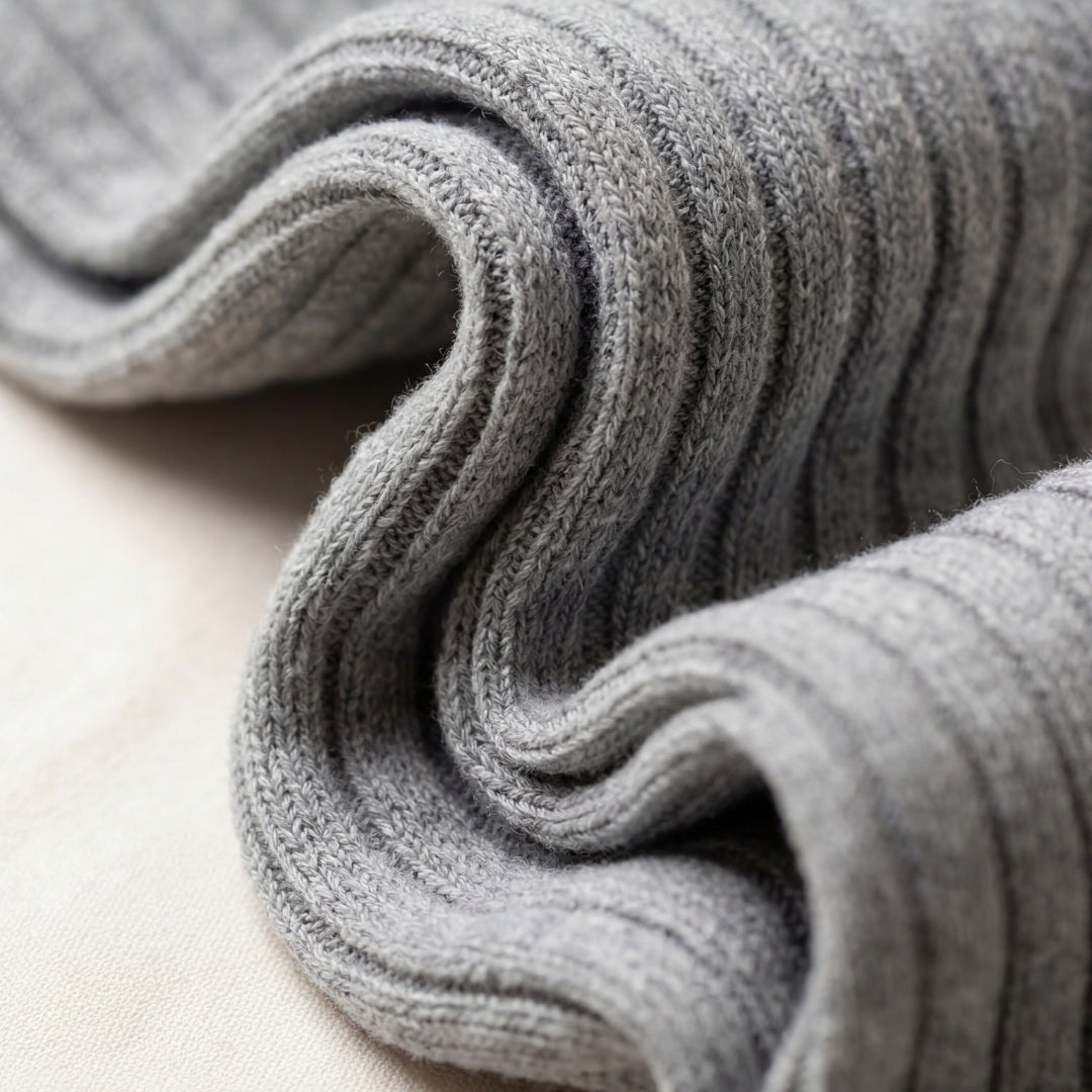 Folded gray fabric on a light beige surface