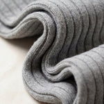Folded gray fabric on a light beige surface
