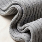 Folded gray fabric on a light beige surface
