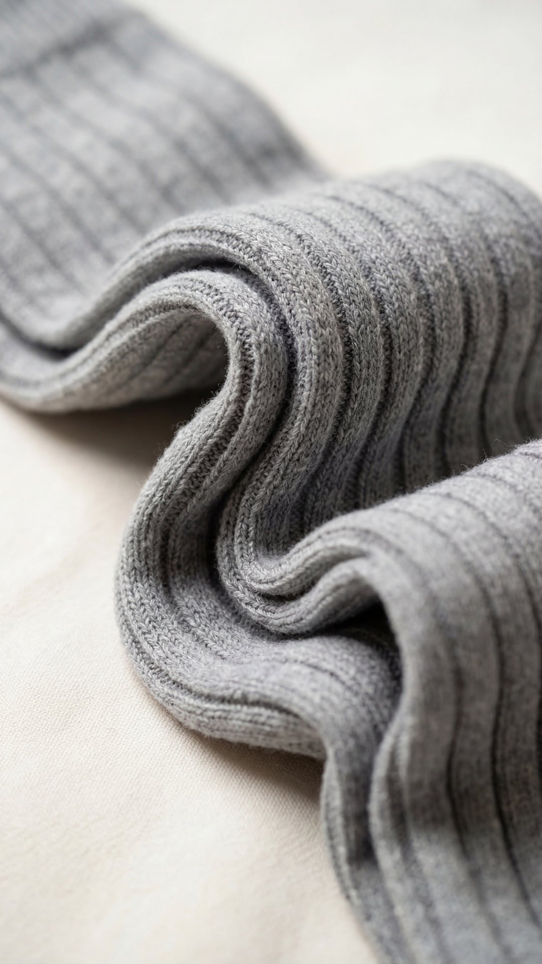 Folded gray fabric on a light beige surface