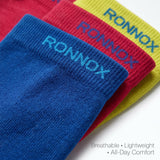 Four ribbed knit socks in blue, red, and yellow, each with the brand name 'RONNOX' printed in blue on the cuff, arranged diagonally on a white background with text reading 'Breathable • Lightweight • All-Day Comfort'.