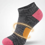 Gray and pink sock with arch support on a light gray background