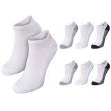 Six pairs of low-cut ankle socks shown on a plain white background, including two large white pairs and four smaller white pairs with gray or black accents.