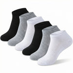 Set of black, gray, and white socks on a light gray background