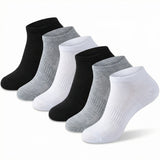 Set of black, gray, and white socks on a light gray background