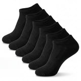 Set of six black ankle socks on a white background