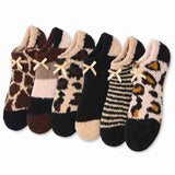 Set of six patterned socks with bows on a white background