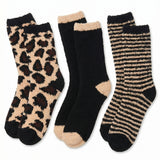 Set of three pairs of socks with leopard print, black and beige, and striped patterns on a white background.