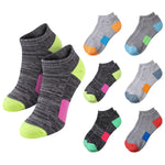Six pairs of low-cut ankle socks arranged on a white background. The main pair in the foreground is heather dark gray with neon green toe and heel sections, pink side panel, and purple heel accent.