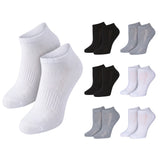 Six pairs of low-cut ankle socks shown on a plain white background: two white pairs large on the left and four smaller pairs arranged to the right, including black, light gray, and white variants.