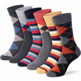 Six pairs of men's crew socks arranged in a fan shape on a white background. The socks feature various color combinations including argyle patterns and striped designs in gray, navy, red, yellow, and blue.