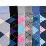 Six pairs of men's dress socks with argyle diamond patterns, shown in a side-by-side vertical arrangement. The colors include light blue, black, gray, navy, pink, and blue, with some pairs featuring yellow and purple accents.